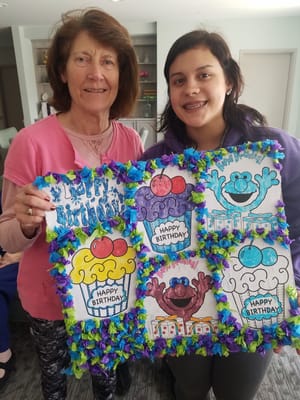 Residents celebrating a birthday with crafts and decorations