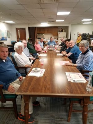 Residents gathered around a large dining table