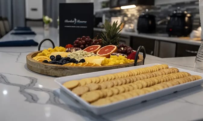 A beautifully arranged fruit and cracker platter in the dining area