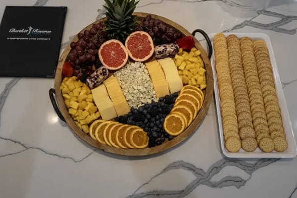 A colorful fruit and cheese platter on a table