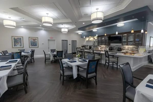 Bright dining room with tables and chairs set up