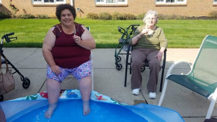 Two women enjoying a sunny day outdoors with ice cream