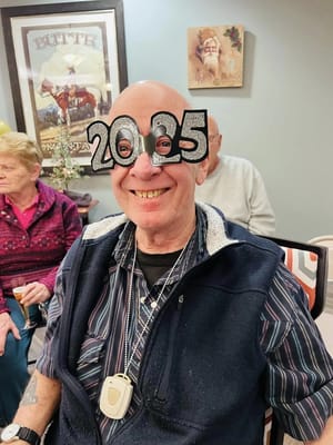 Resident celebrating with glasses at a New Year's party