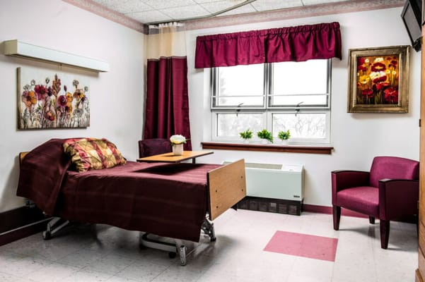 Cozy resident room with a bed and chair