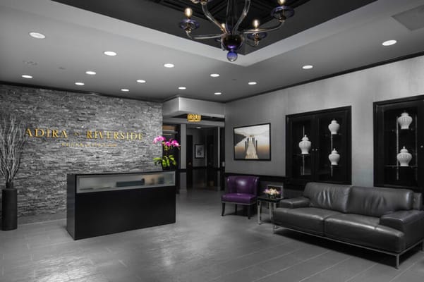 Modern lobby area with a reception desk and seating