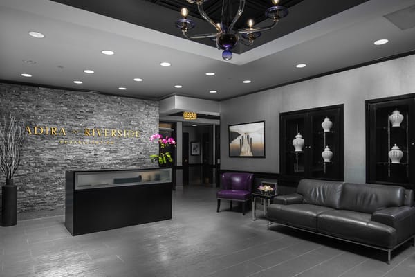 Modern lobby area with a reception desk and seating