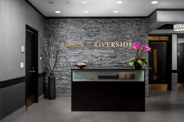 Modern reception area with stone wall and flowers