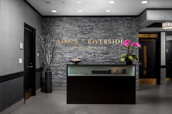 Modern reception area with stone wall and flowers