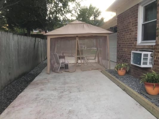 Outdoor gazebo area with table and chairs