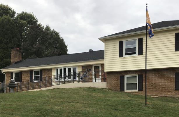 Exterior view of Russell Residence with a flag.