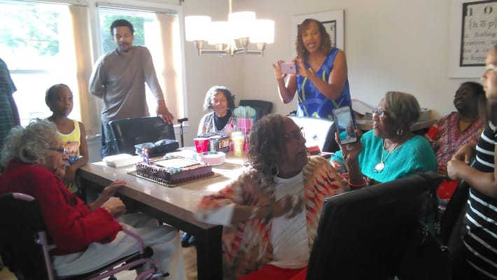 Residents celebrating a birthday in a common area