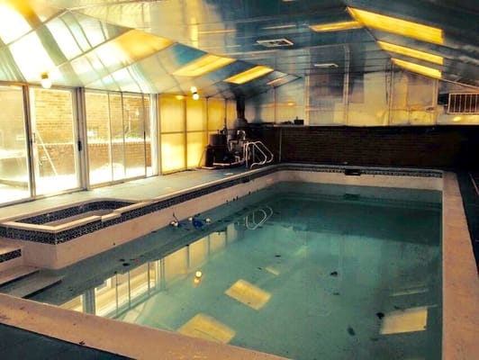 Indoor swimming pool area with glass walls