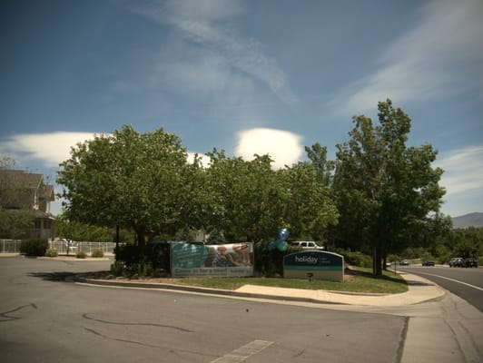 Exterior view of Holiday Sky Peaks entrance with trees