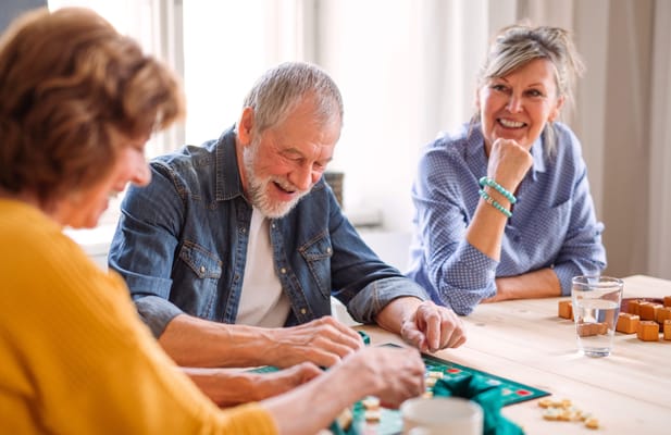 Residents playing a board game at a table