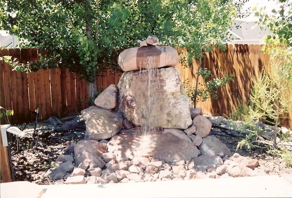 A natural stone water feature in a garden