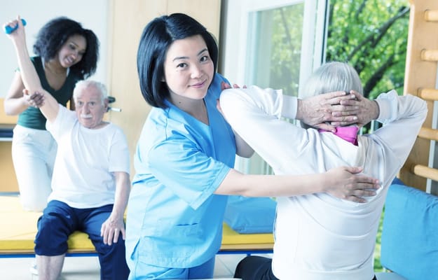Staff assisting residents in an activity room
