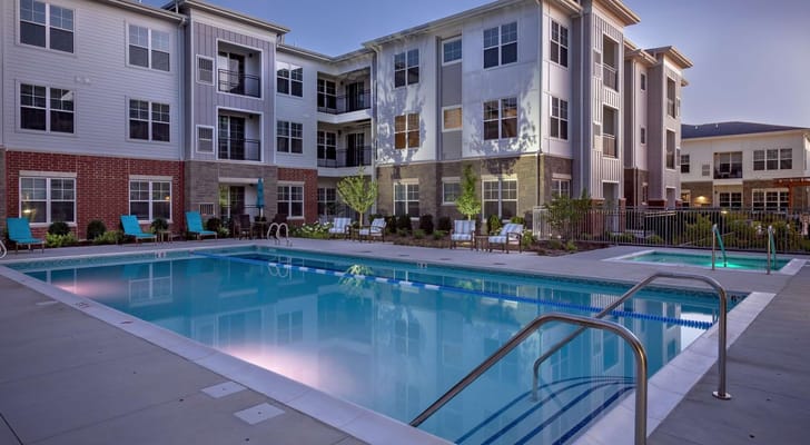 Swimming pool area with seating and landscaping