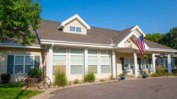 Exterior view of Floyd Senior Living facility with porch and flag
