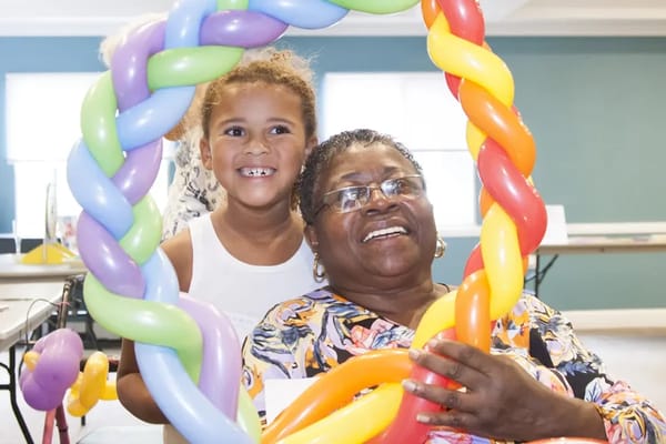 Residents and a child enjoying a fun activity together