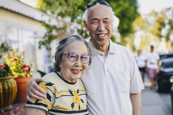 Happy elderly couple posing outdoors
