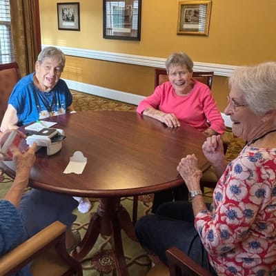 Residents engaged in conversation around a table
