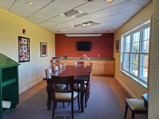 Interior view of a meeting room with large table and chairs