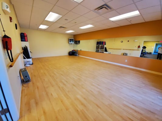 Bright and spacious activity room with wooden flooring