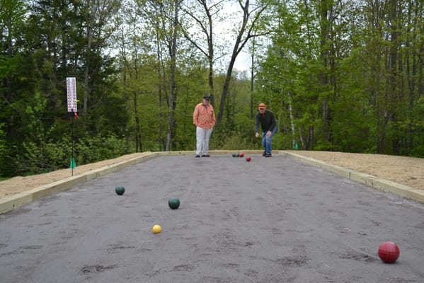 Two residents playing bocce ball in a park