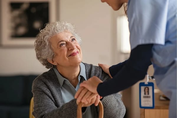 Staff member interacting with a resident in a cozy setting