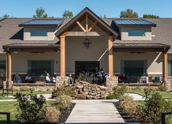Building exterior view of Crestview Senior Living with residents outside