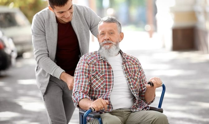 Staff member assisting a resident in outdoor setting