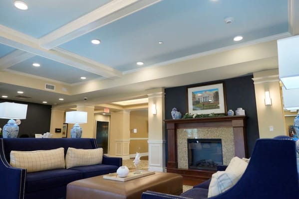 Bright lounge area with comfortable seating and fireplace