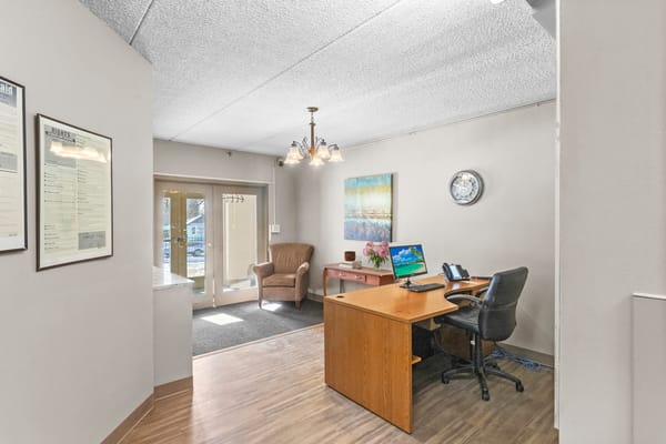 Reception area of a senior living facility with desks and seating
