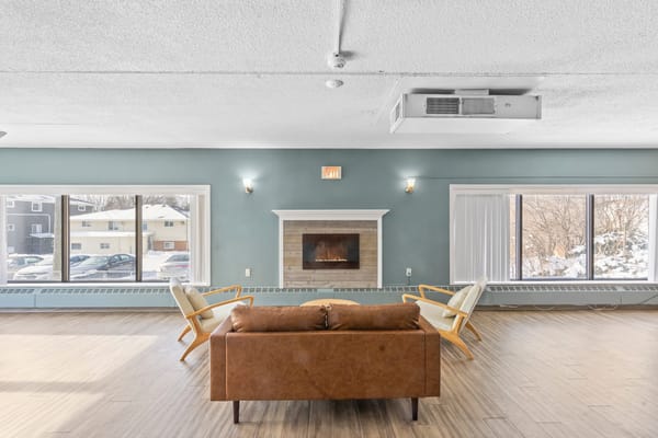 Bright common area with seating and fireplace