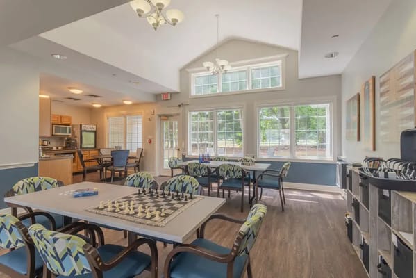 Interior common area with chess tables and large windows