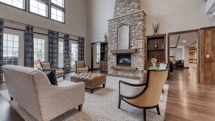 Bright common area featuring comfortable seating and a fireplace