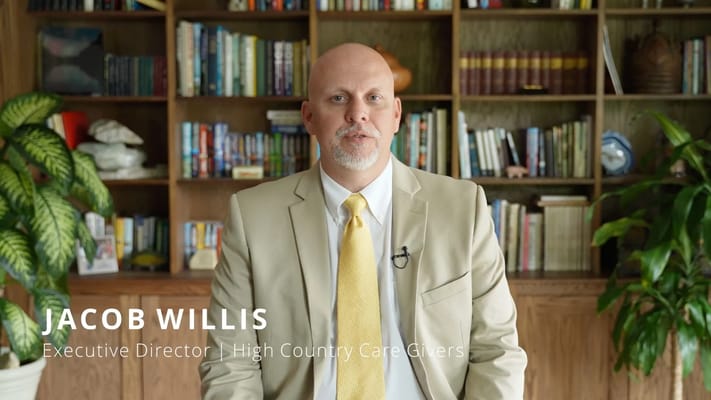 Executive Director in front of a bookshelf
