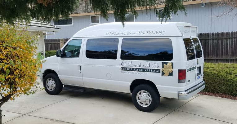 Facility transport van parked in front of building