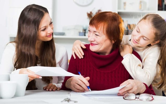 Family engaging with a senior in a cozy interior setting