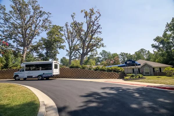 Facility exterior with shuttle bus and building entrance