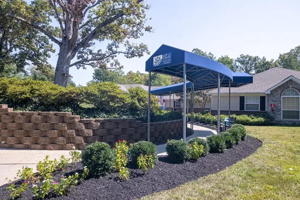 Covered entrance with outdoor landscaping