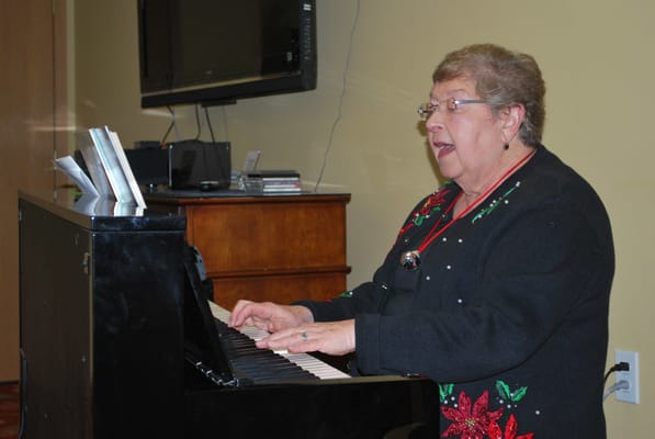 Senior resident playing piano during an activity