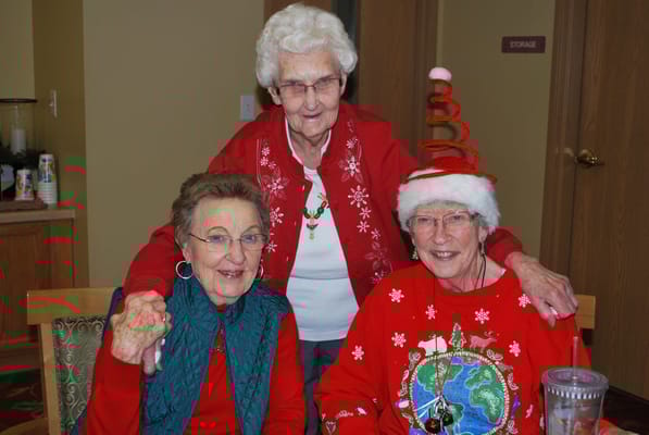 Three senior women celebrating in festive attire