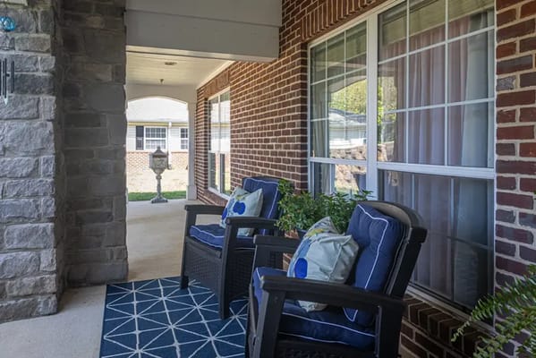 Seating area with chairs and cushions in a covered outdoor space