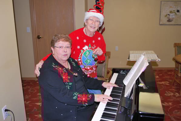 Two residents enjoying music during a holiday celebration