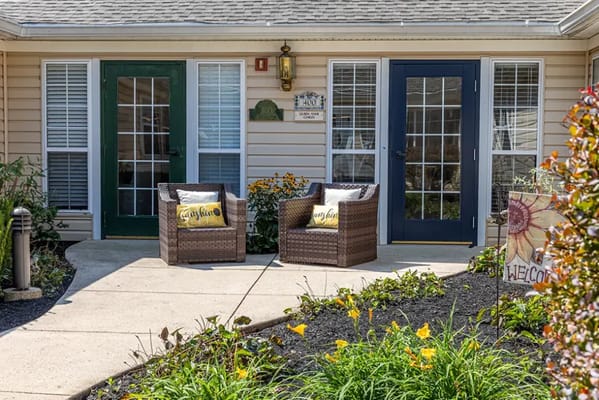 Outdoor seating area with two chairs and flowers