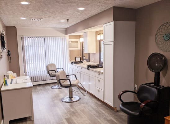 Hair salon area with styling chairs and natural light