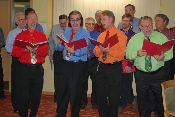 Residents singing in a colorful attire during an event