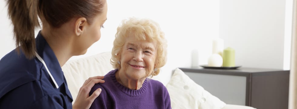 Staff interacting with a resident in a cozy setting
