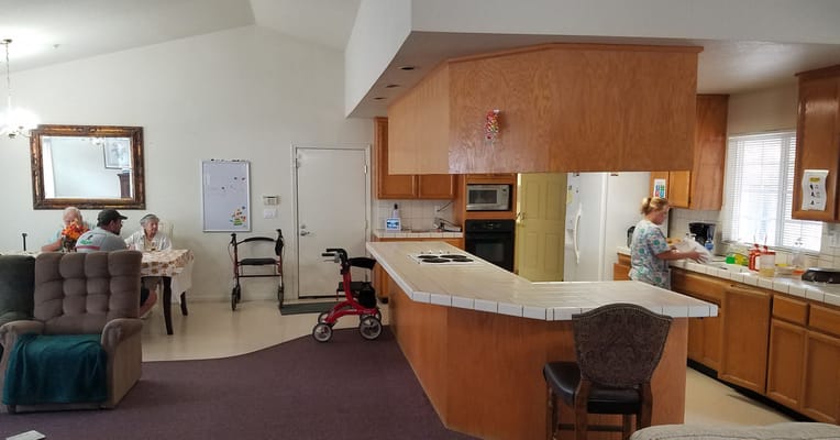 Activity room with residents and staff preparing food.